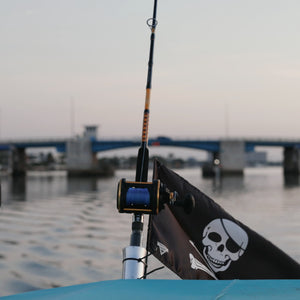 Ugly Stik conventional rod secured on a boat with open water in the background.