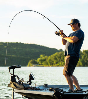 Man fishing with Ugly Stik GX2 off a boat on a freshwater lake