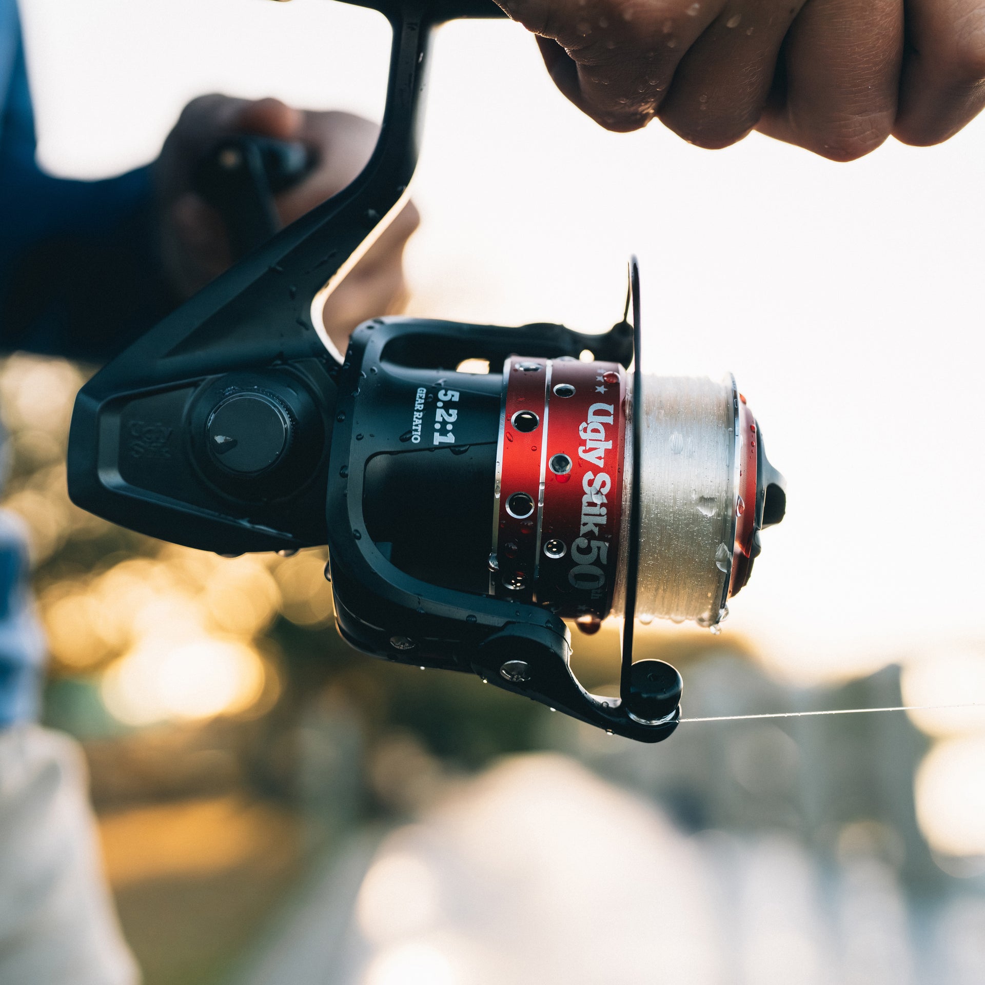 Ugly Stik 50th Spinning Reel with a blurred natural background