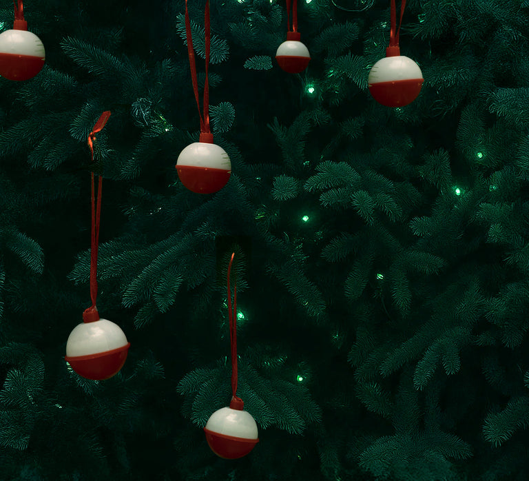 Red and white ornaments hanging on a Christmas tree
